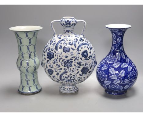 Two Chinese blue and white vases and a similar moon flask, moon flask 28 cms high.