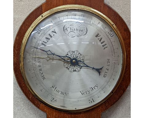 A mahogany wheel barometer. Length -107cm, W-32cm.