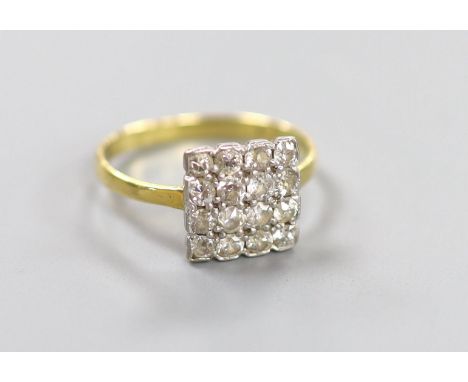 An 18ct and sixteen stone diamond set cluster tablet ring, size O, gross 2.5 grams.