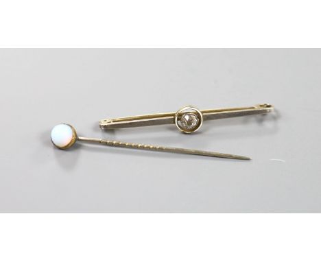 A yellow metal and solitaire diamond set bar brooch, 50mm and a single stone opal set stick pin.