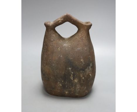 An Egyptian pottery flask, 23 cms high