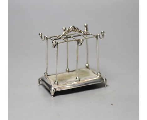 An Edwardian silver mounted hat pin? and ring stand, Mappin Bros. Birmingham, 1909, height 8.1cm.