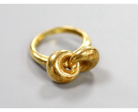 A 750 yellow metal  'knot' ring, size L, 6.4 grams.
