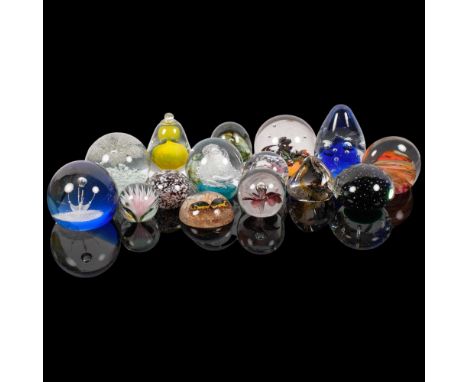 A collection of 14 glass paperweights, including Caithness, and a plastic insect paperweight, includes basket 