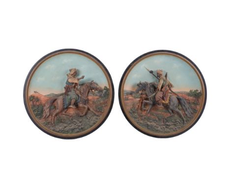 A pair of 3-dimensional Austrian terracotta painted wall plaques, by J M Musterschutz, depicting an Arabian warrior on a hors