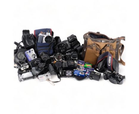 A selection of Vintage cameras and associated accessories, including a Fujifilm Finepix S, an Olympus OM20, a Canon EOS500, a