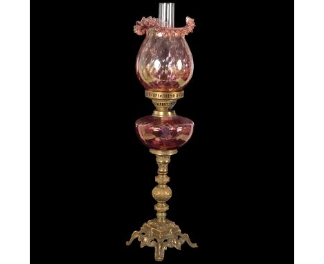An Antique Duplex glass and brass oil lamp, with a frilled red glass shade and matching font, H68cmIn good overall condition,