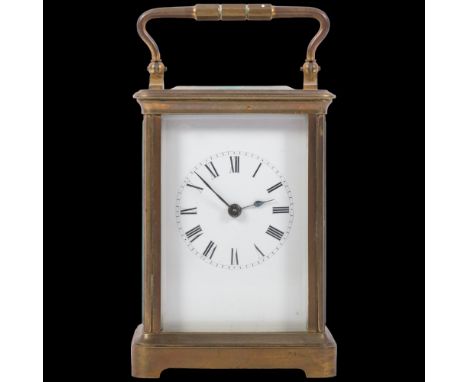 An Antique brass-cased carriage clock with striking movement, white enamel dial and carrying handle, height not including han