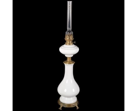 An Art Nouveau brass and white ceramic oil lamp, H80cmGeneral surface scratches and marks to the body, some of the brass moun