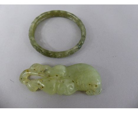 A Pierced and Carved Green Jade Bangle, 7cm Diameter and a Carved Jade Amulet. 8.5cm Long