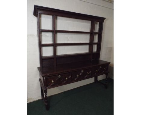 An Early Oak Shropshire Dresser. The Three Fielded Drawers with Brass Handles and Escutcheons. Turned Supports. Raised Three 
