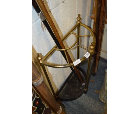 A brass and cast iron demi-lune walking stick stand.