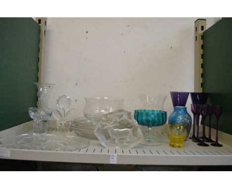 A shelf of decorative and household glass.