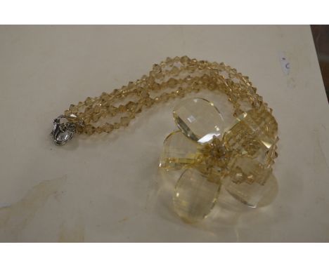 A Butler &amp; Wilson flower head pendant and chain.