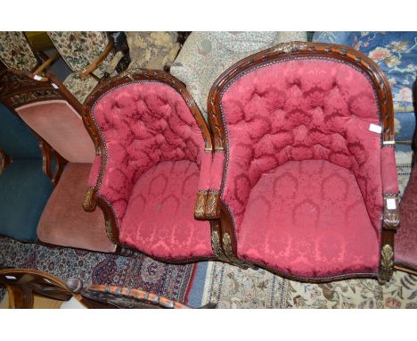 A good pair of carved mahogany and parcel gilt framed button upholstered armchairs.