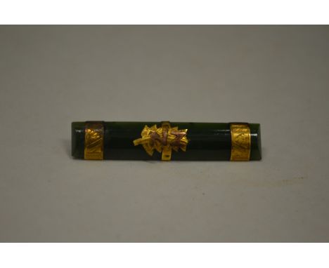 A gold and jade bar brooch.