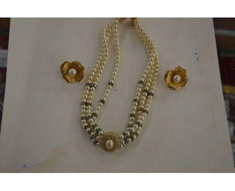A Christian Dior necklace and a pair of similar flower head ear studs.