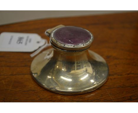 A small silver and enamel capstan inkwell.