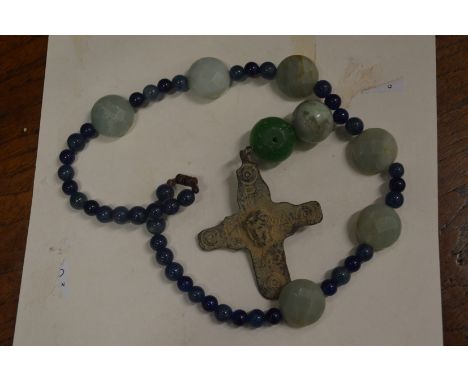 A Roman bronze cross on a bead necklace.