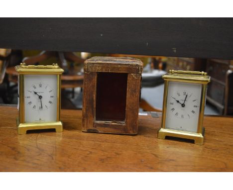 Two brass carriage clocks and an old carriage clock case.