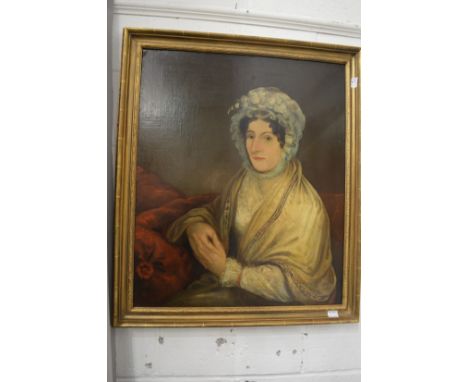 A portrait of a seated lady wearing a bonnet and a shawl, oil on canvas in a decorative gilt frame.