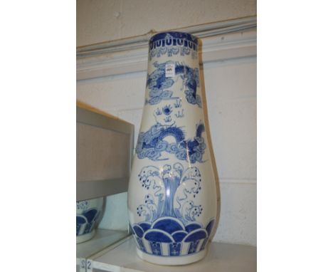 A large Chinese blue and white tapering vase or stick stand.