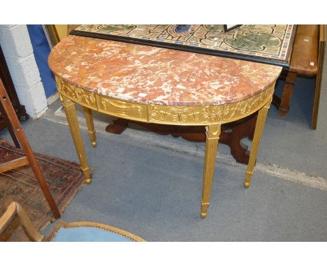 A good giltwood demi-lune console table with classical decoration and variegated rouge marble top.