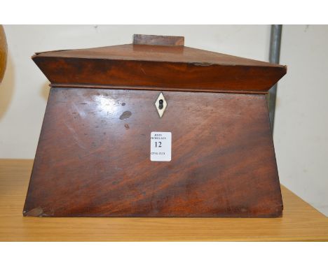 A mahogany sarcophagus shaped tea caddy.