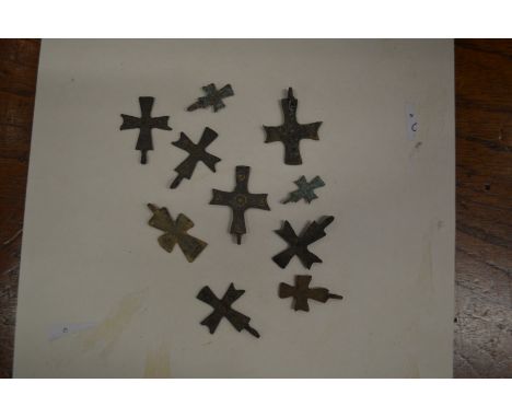 A collection of small Roman bronze crosses.