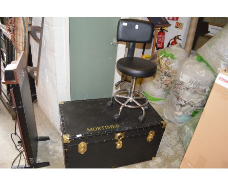 A typist's chair and a large trunk.