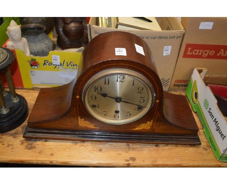 A mahogany mantle clock.