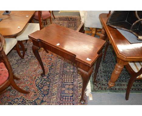 A George III mahogany foldover card table on cabriole legs.