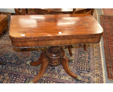 A 19th century mahogany D-shaped foldover card table on a fluted column support with four outswept legs with brass castors.