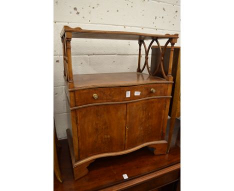 A small yew wood lamp table or side cabinet with a single drawer and a pair of doors.