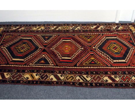 A 20th century Caucasian Chivran carpet, the flatweave long rug also referred to being from Shivran with three medallions wit