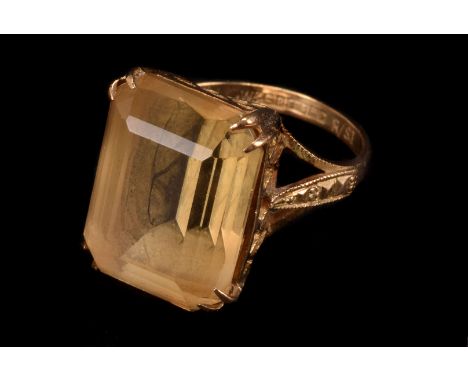 A modern 9ct gold and citrine dress ring, the large yellow stone in basket mount, size K