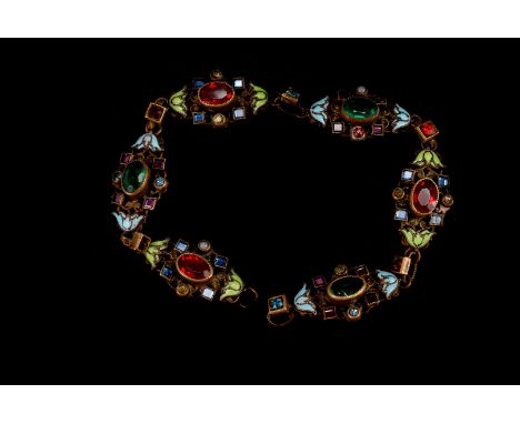 A pretty Austro-Hungarian gilt bracelet, the shaped and pierced links with enamel leaf ends and set with paste stones