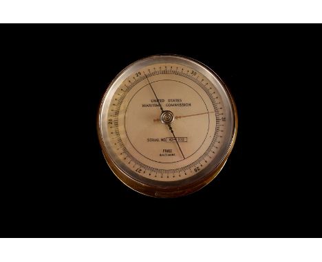A vintage US ship's barometer by Friez, in brass case, marked to dial with United States Maritime Commission and serial no. 4