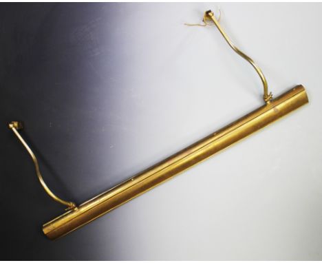 Four brass coated gallery lights, each with an arched canopy mounted upon a pair of adjustable curved supports, 98cm long Lig