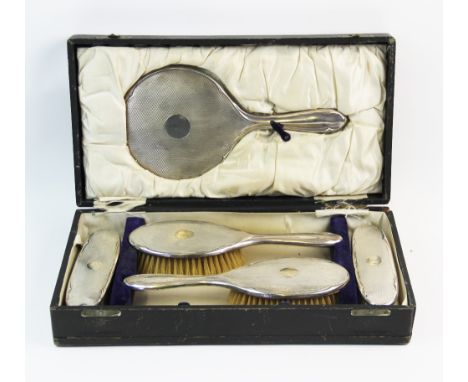 A George V silver back dressing table set, F R Gomm, Birmingham 1919, comprising; a hand mirror, two brushes and two clothes 