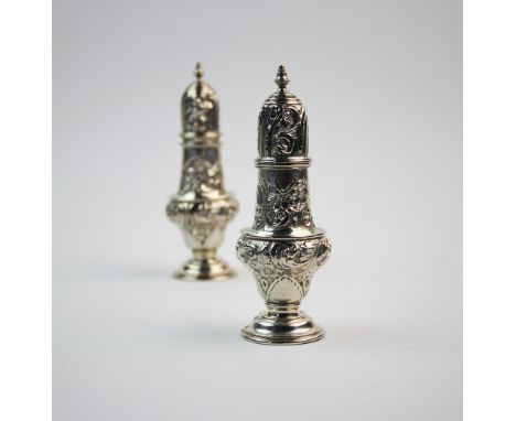 A pair of Victorian silver sugar casters, William Aitken, Chester 1900, each of baluster form, decorated with scrolling folia