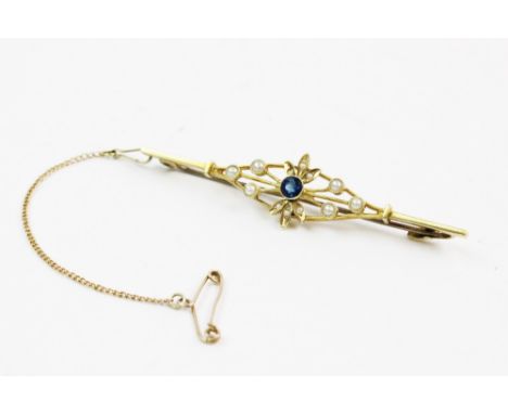 An Edwardian seed pearl set bar brooch, comprising an untested old-cut blue gemstone measuring 4mm, collet set to a pierced d