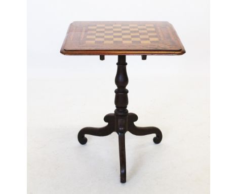 A Victorian mahogany pedestal games table, the square moulded top centred with an inlaid chequered games board, flanked by cr