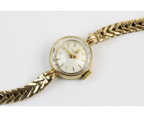 A lady's 9ct gold vintage Omega wristwatch, the cream coloured dial with gold-toned baton markers, set to a round 9ct yellow 