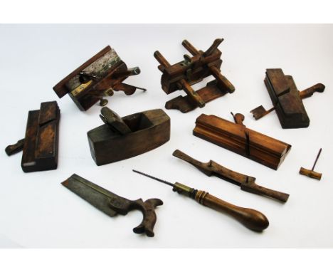 A collection of late 19th century woodworking tools, to include two plough planes with brass fittings, a smoothing plane, nin