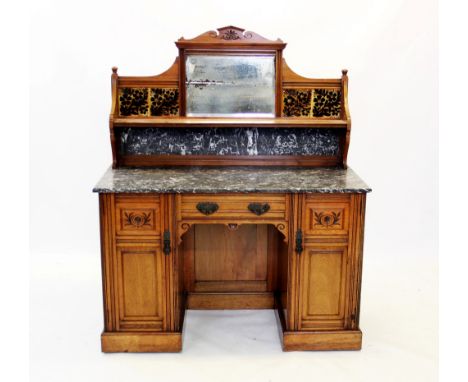 A late Victorian walnut tile back washstand by Lamb of Manchester, with an architectural pediment above a mirror back flanked