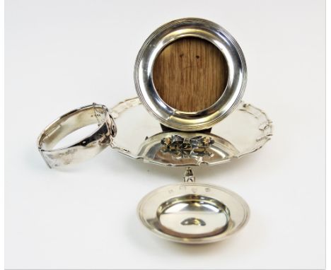 A silver waiter, Edward Barnard &amp; Sons Ltd, London 1972, with plain polished tray and pie crust rim, on three scroll feet
