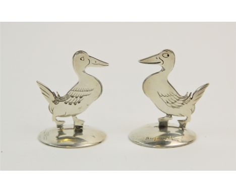 A pair of silver place card holders, Sampson Mordan & Co Ltd, Chester 1912/1914, each modelled as a duck 'Gedeon', after desi