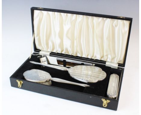 A silver backed dressing table set, W I Broadway & Co, Birmingham 1976, comprising: a hand mirror, a hair brush, clothes brus