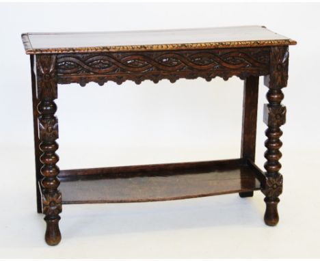 A Victorian carved oak side table, the rectangular moulded top above a frieze carved with a geometric interlaced design, rais